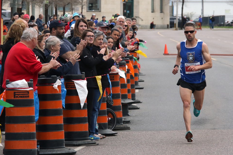 Trevor Zimak gets set to cross the finish line in first place on Monday, May 22, 2017 during the 84th running of the Firefighters Ten Mile Road Race (Leith Dunick, tbnewswatch.com)