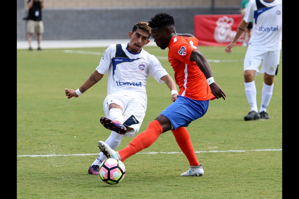 Thunder Bay's German Alfaro (left) boots the ball past Charlotte's Hazeley Pyle on Saturday, Aug. 5 at the Matthews Sportsplex during the Premier Development League final (Leith Dunick, tbnewswatch.com). 