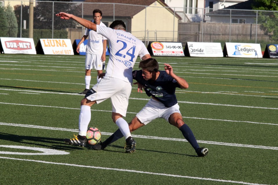 Andres Garza checks checks Thunder Bay's Patricio Arce during the Chill's 3-1 loss to Saint Louis FC U18. (Michael Charlebois, tbnewswatch.com)