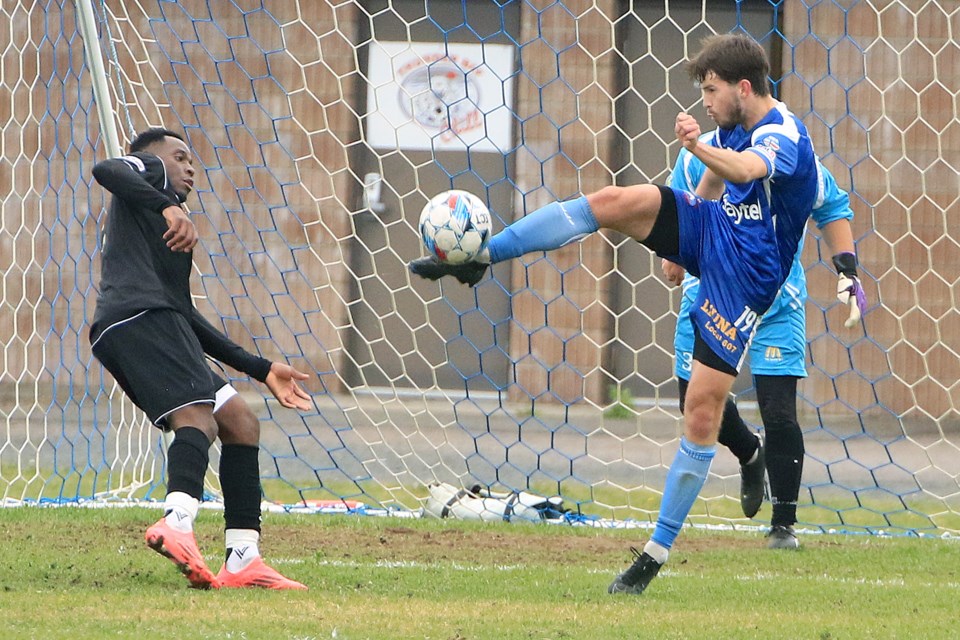 The Chill's Daniel Peace boots the ball out of harm's way, standing in front of keeper Erik Aegard. (Leith Dunick, tbnewswatch.com)