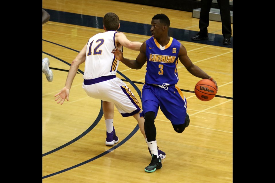 Lakehead's NIck Burke works the ball around Laurier's Matthew Chesson on Saturday, Feb. 18, 2017 at the Thunderdome (Leith Dunick, tbnewswatch.com).