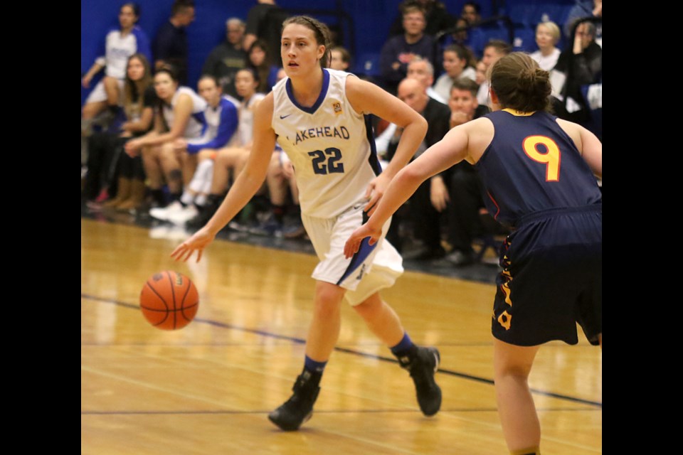 Lakehead's Bridget O'Reilly circles the key with Queen's defender Katharina Holt in pursuit on Friday; Nov. 25; 2016 at the Thunderdome (Leith Dunick; tbnewswatch.com).