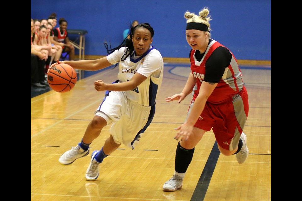 Lakehead's Tianna Warwick (left) attempts to blast by Algoma's Madison Cameron on Friday, Oct. 13, 2017 at the Thunderdome (Leith Dunick, tbnewswatch.com). 