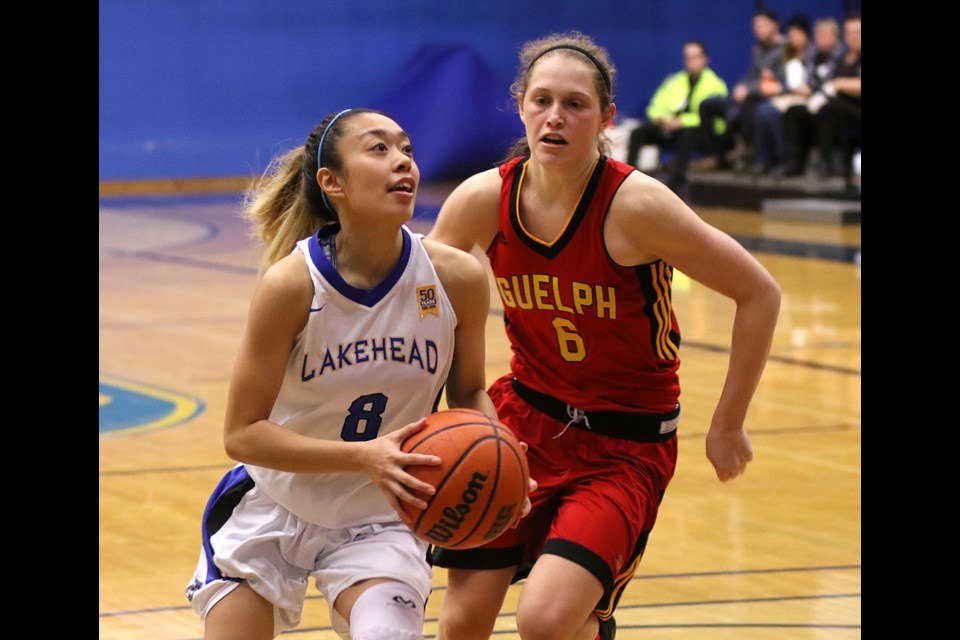 Lakehead's Nikki Ylagan (left) bursts past Guelph's Megan Brenkel on Friday, Jan. 5, 2018 at the C.J. Sanders Fieldhouse. (Leith Dunick, tbnewswatch.com)