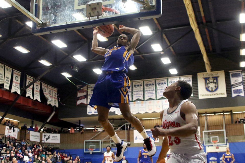 Lakehead's Davarius Wright dunks over Algoma's Brandon Dwyer on Saturday, Oct. 27, 2018 at the C.J. Sanders Fieldhouse. (Leith Dunick, tbnewswatch.com)