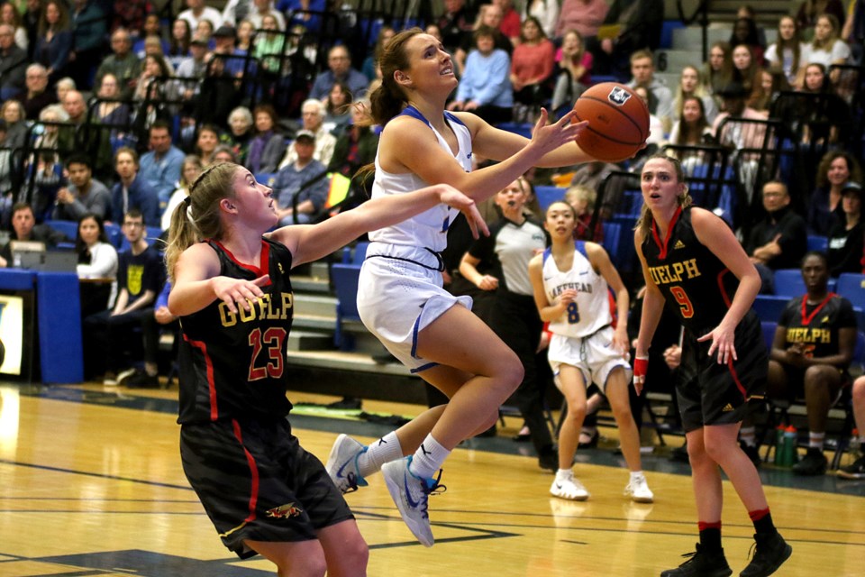 Lekehead's Sofia Lluch goes up against Guelph's Burke Bechard (left) and Ivana Vujadinovic on Saturday, Feb. 23, 2019 at the C.J. Sanders Fieldhouse. (Leith Dunick, tbnewswatch.com)