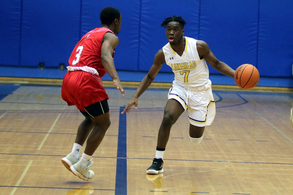 Lakehead's Laoui Msambya (right) carries the ball down the court past York's Joshua Kaoande on Friday, Nov. 29, 2019 at the C.J. Sanders Fieldhouse. (Leith Dunick, tbnewswatch.com)
