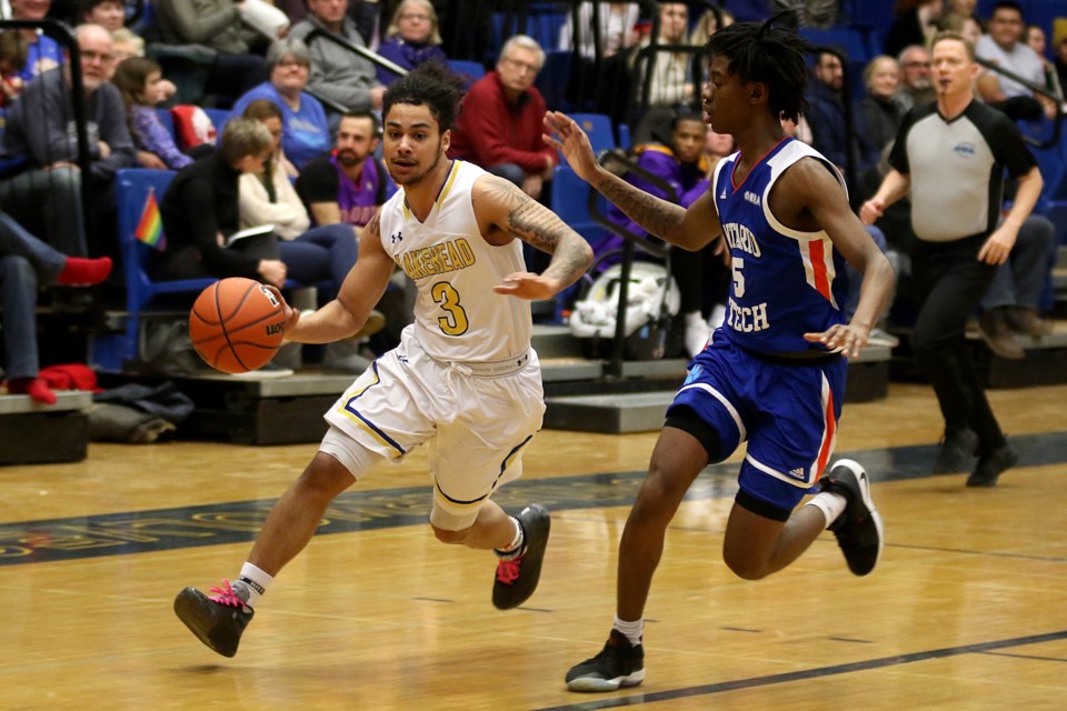 Lakehead's Alston Harris (left) looks for a way to drive past UOIT's A.J. Cummings on Friday, Feb. 14, 2020. (Leith Dunick, tbnewswatch.com)