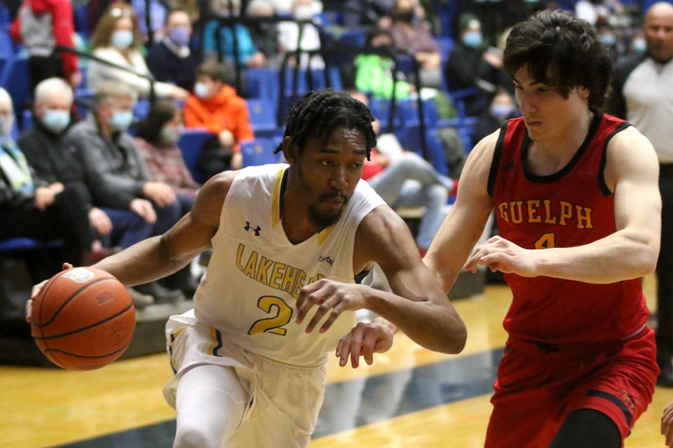 Dylan Morrison (left) drives past Guelph's Felix Janusauskas on Friday, Feb. 11, 2022. (Leith Dunick, tbnewswatch.com)