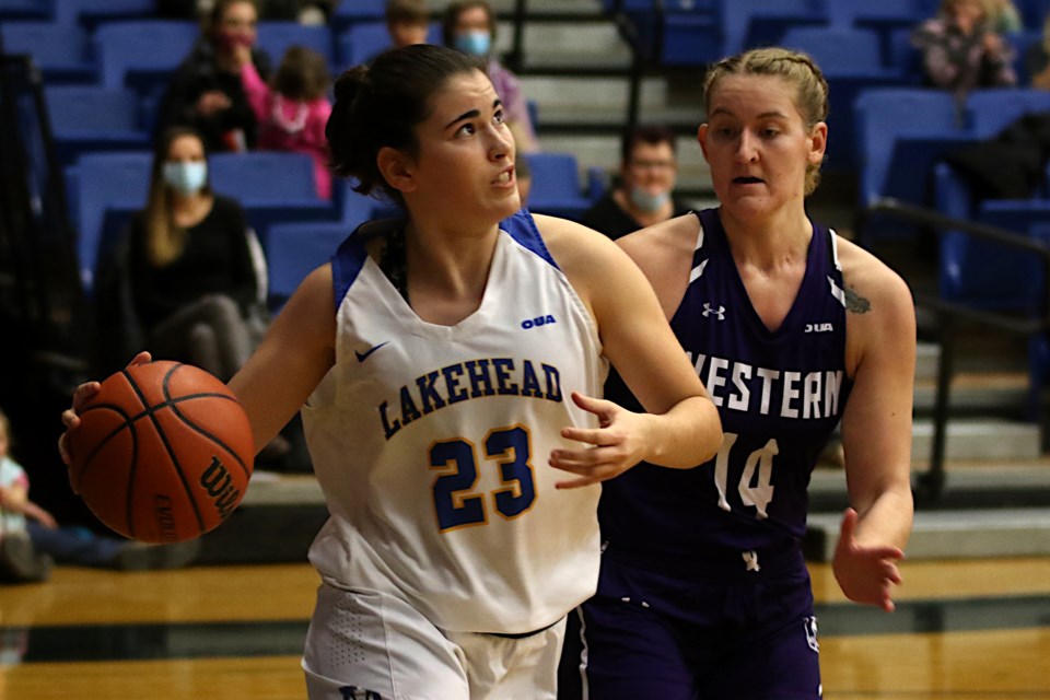 Eva Guillera drives the paint against Western's Brett Fischer on Friday, Nov. 26, 2021. (Leith Dunick tbnewswatch.com)