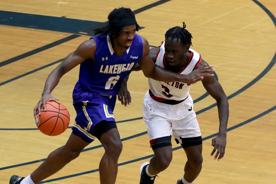 Lakehead's Michael Okafor (left) brushes off Carleton's Marjok Okado on Saturday, Feb. 18, 2023 at the C.J. Sanders Fieldhouse. (Leith Dunick, tbnewswatch.com)