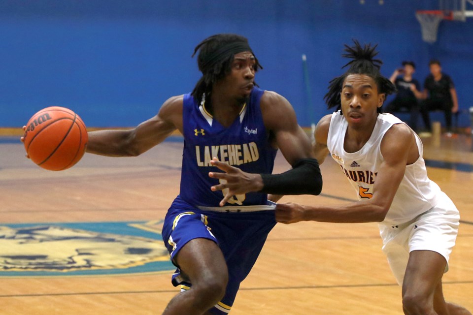 Michael Okafor drives the paint against Laurier's Jahmyah Brown Jeffers on Saturrday, Nov. 19, 2022 at the C.J. Sanders Fieldhouse. (Leith Dunick, tbnewswatch.com)