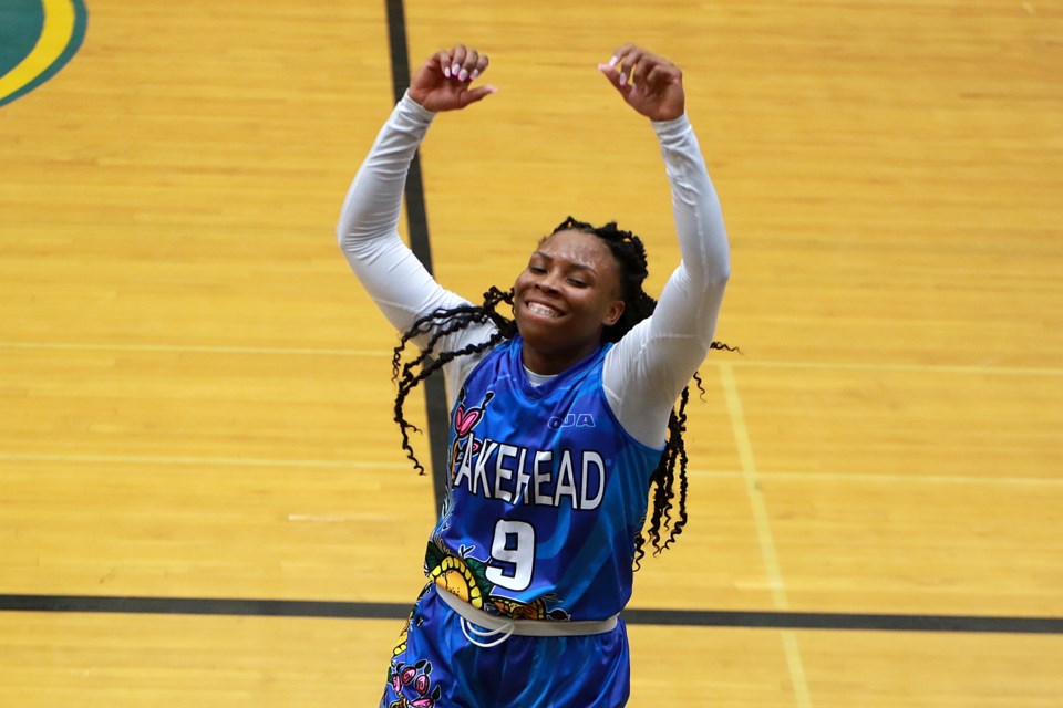 Tiffany Reynolds celebrates after scoring the 1,000th point of her Lakehead University basketball career, on Friday, Feb. 17, 2023. (Leith Dunick, tbnewswatch.com)