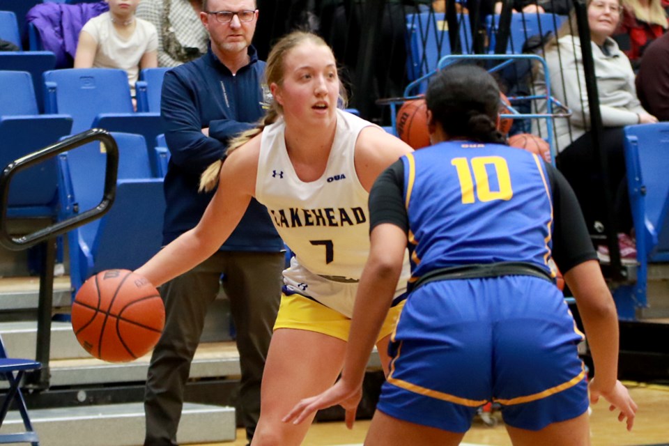 Hana Whalen looks for an open teammate, while TMU's Jayme Foreman guards her on Friday, Feb. 3, 2023 against the Toronto Metropolitan Bold at the C.J. Sanders Fieldhouse. (Leith Dunick, tbnewswatch.com)