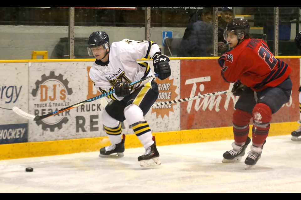 Lakehead's Austin McDonald chases down the puck on Saturday, Jan. 7, 2017 at Fort William Gardens, pursued by Brock's Josh Timpano (Leith Dunick, tbnewswatch.com). 