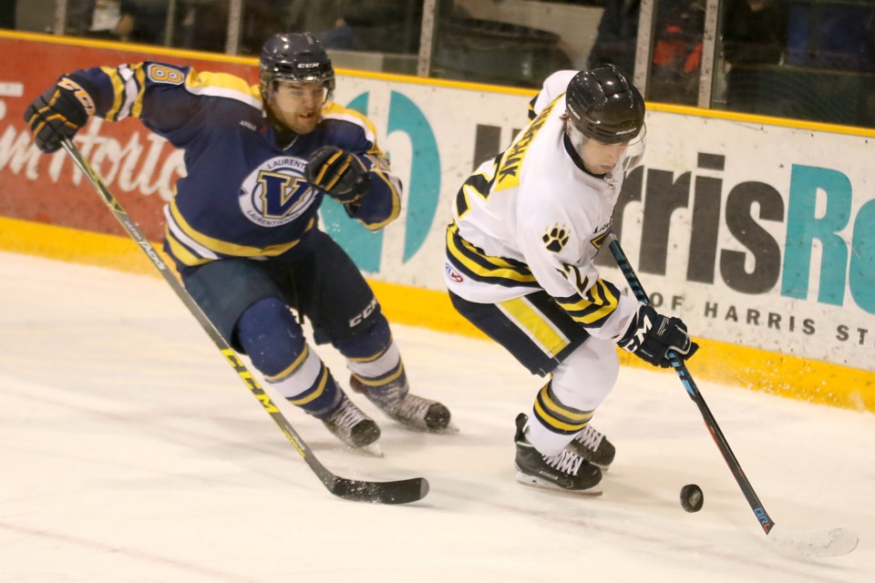 Lakehead's Brennen Dubchak take the puck around the Laurentian net, chased by Voyageurs forward Francois Cote on Friday, Jan. 20, 2017 at Fort William Gardens (Leith Dunick, tbnewswatch.com). 