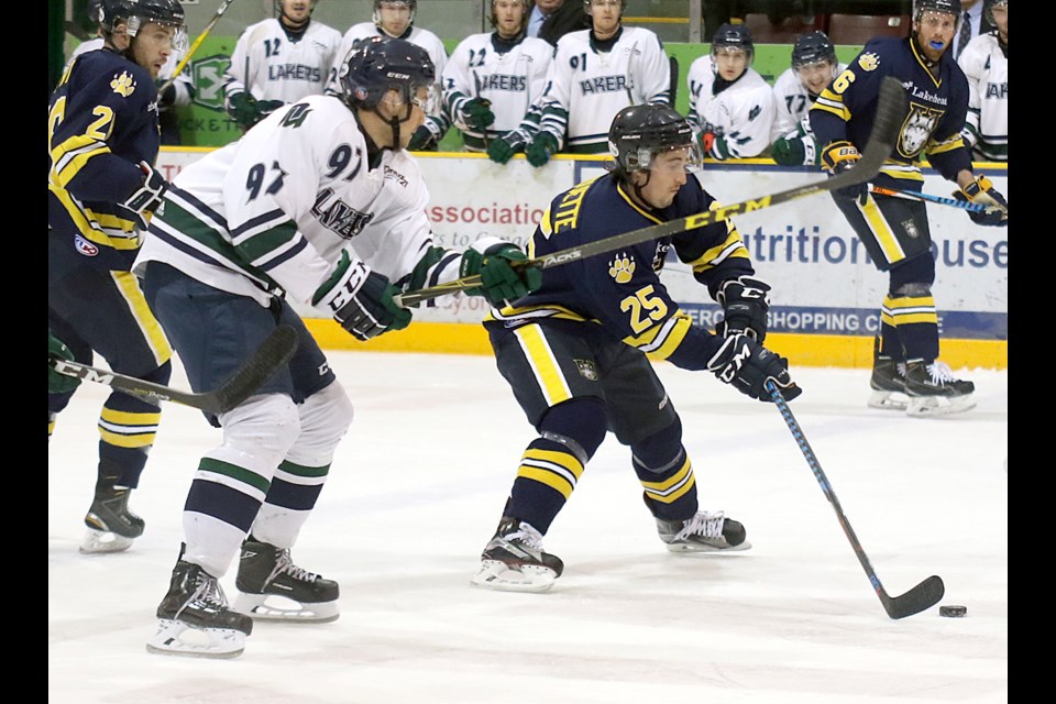 Lakehead's Grant Valiquette attempts to escape the clutches of Nipissing's Drake Lindsay in the second period on Thursday, Dec 29, 2016 at Fort William Gardens (Leith Dunick, tbnewswatch.com). 