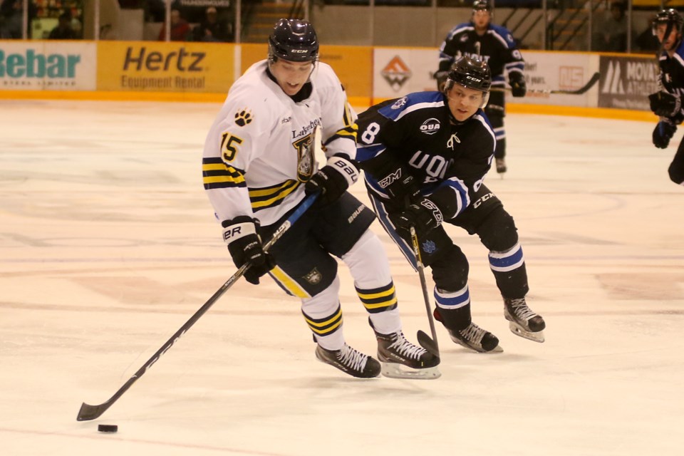 Lakehead's Josh Laframoboise beats UOIT's Danny Elser to the puck on Friday, Sept. 29, 2017 (Leith Dunick, tbnewswatch.com). 