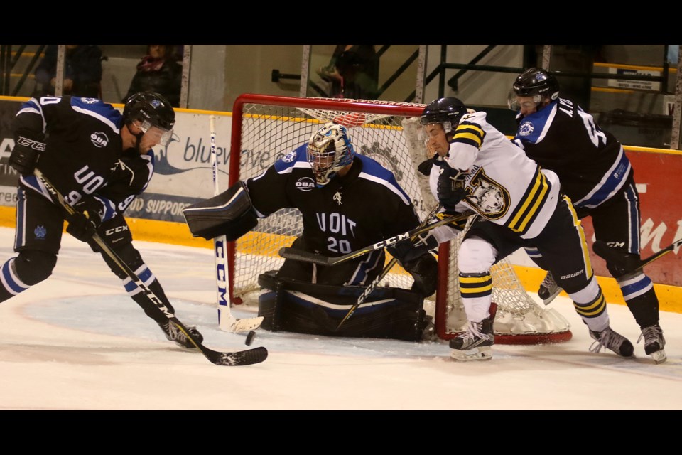 Grant Valiquette attempts to wrap the puck around the net and past UOIT goaltender Tyson Teichmann on Saturday, Sept. 30, 2017 at Fort William Gardens (Leith Dunick, tbnewswatch.com). 