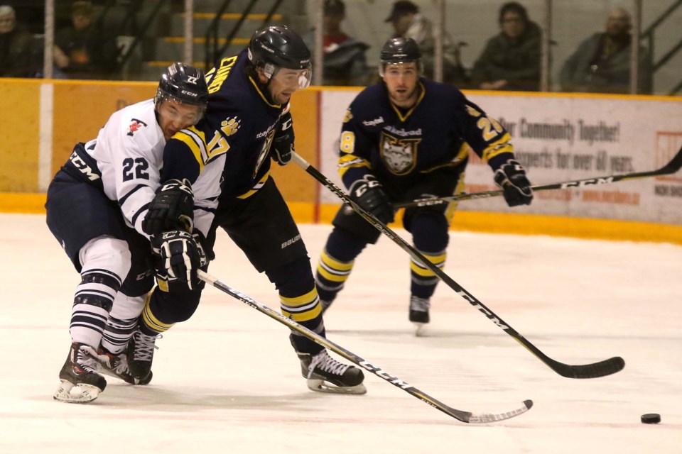 Toronto's Willy Paul (left) is draped all over Lakehead's Matt Alexander on Friday, Nov. 17 ,2017 at Forrt WIlliam Gardens. (Leith Dunick, tbnewswatch.com)