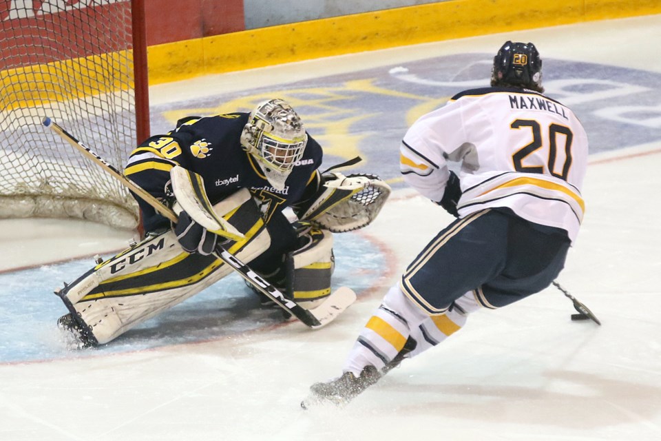 Devin Green stops Lethbridge's Brooks Maxwell on a first-period breakaway on Saturday, Sept. 22 at Fort William Gardens. (Leith Dunick, tbnewswatch.com)