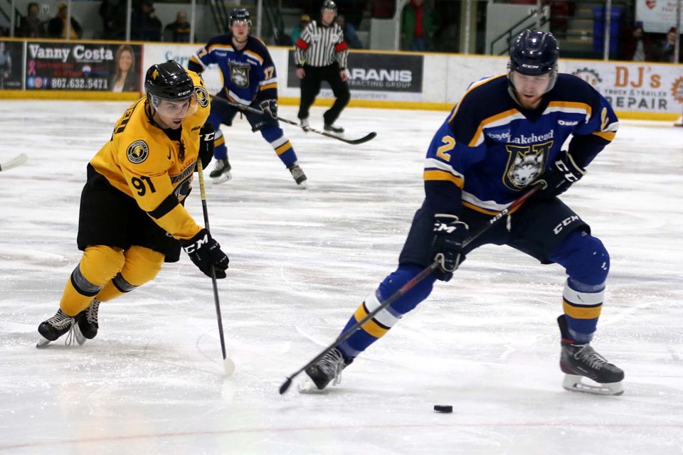 Lakehead's Callum Fryer (right) moves the puck on Saturday, Feb. 8, 2020 with Waterloo's Chase Campbell in pursuit. (Leith Dunick, tbnewswatch.com)