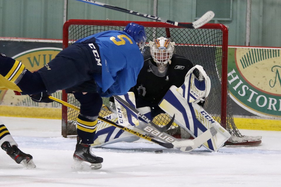 Ben Badalamenti slides the puck through the five-hole of Lakehead goaltender Blake Weyrick during a scrimmage on Monday, Sept. 13, 2021 at the Tournament Centre. (Leith Dunick, tbnewswatch.com)