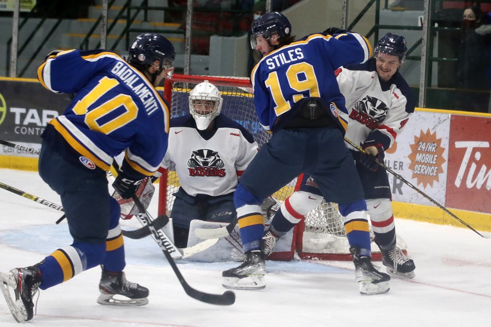 Lakehead's Ben Badalamenti fires the puck at Brock goaltender Mario Peccia on Friday, Feb. 18, 2022, while teammate Kevin Stiles tries to clear Badgers defender Johnny Schaefer out of the way. (Leith Dunick, tbnewswatch.com)
