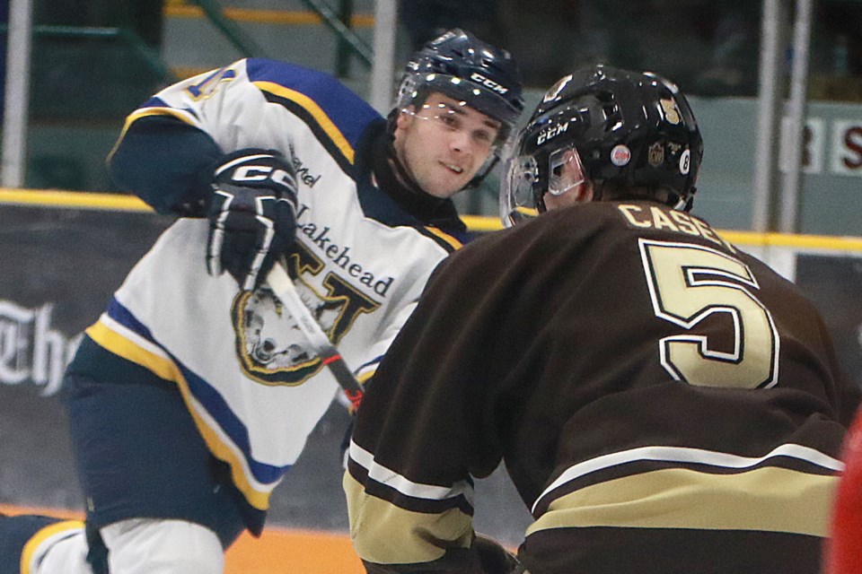 Lakehead's Josh Van Unen fires his second goal of the night, past Manitoba defenceman Brandon Casey, on Friday, Dec. 29, 2023 at Fort William Gardens. (Leith Dunick, tbewswatch.com)