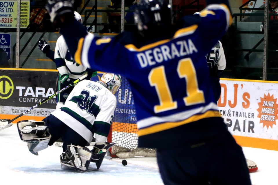 Lakehead's Nick DeGrazia celebrates a first-period goal by teammate Ed McNeill, in the Thunderwolves playoff-clinching, 4-2 win over the Nipissing Lakers at Fort William Gardens on Friday, Feb. 9, 2024. (Leith Dunick, tbnewswatch.com)