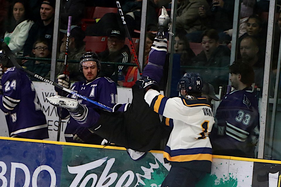 Lakehead's Josh Van Unen punishes Western's Jack Tucker, checking him  into the Mustangs bench on Saturday, Nov. 4, 2023. (Leith Dunick, tbnewswatch.com)