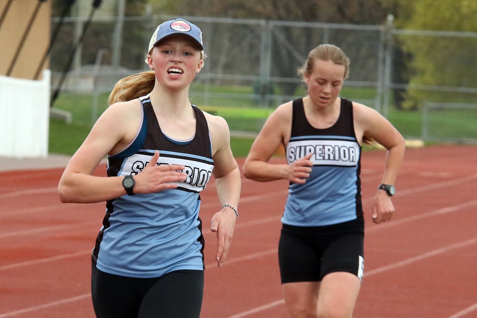 Brooke Ailey (left) and Maaritta Puiras finish first in the senior and junior girls 3,000-metre race at the NWOSSA track and field championships at Fort William Stadium on Thursday, May 26, 2022. (Leith Dunick, tbnewswatch.com)