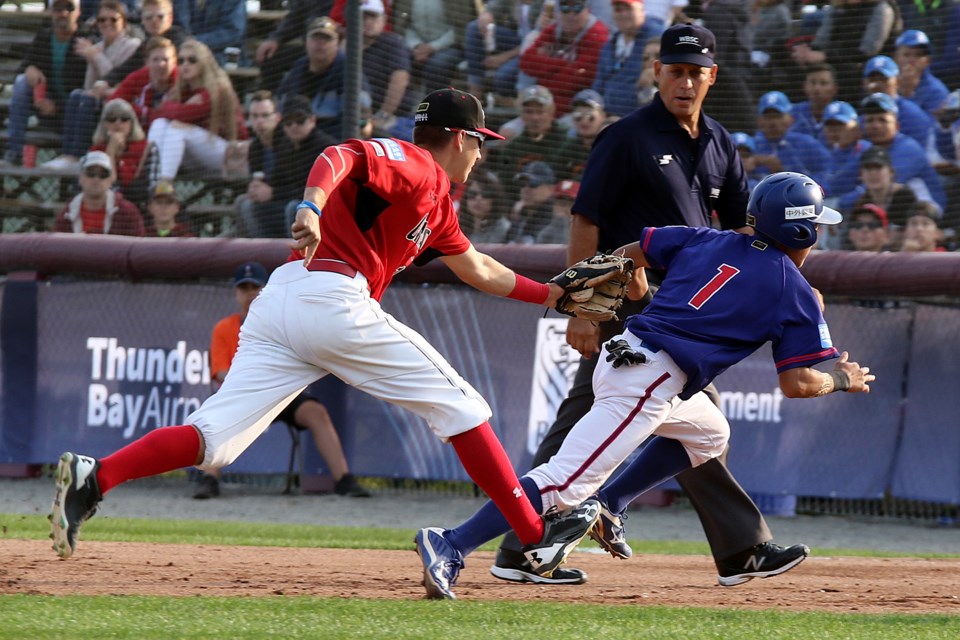 Canada's Jason Willow (left) catches Chinese Taipei's Tien-Hain Kuo in a rundown in the first innning of a U18 Baseball World Cup game at Port Arthur Stadium (Leith Dunick, tbnewswatch.com). 