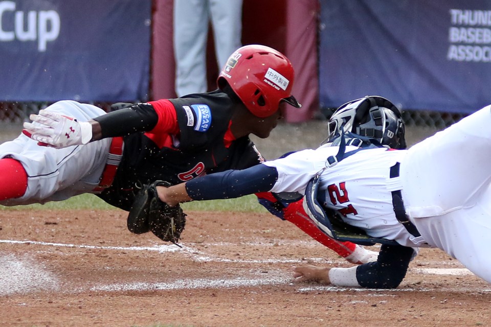 Canada's Denzel Clarke (left) is tagged out at the plate in the second inning by a diving American catcher Anthony Siegler on Thursday, Sept. 7, 2017 at Port Arthur Stadium (Leith Dunick, tbnewswatch.com). 