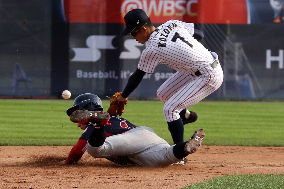 USA's Jarred Kalenic dives back safely to second after Japan shortstop Kaito Kozono can't corral the pick-off attempt on Saturday, Sept. 1, 2017 (Leith Dunick, tbnewswatch.com). 