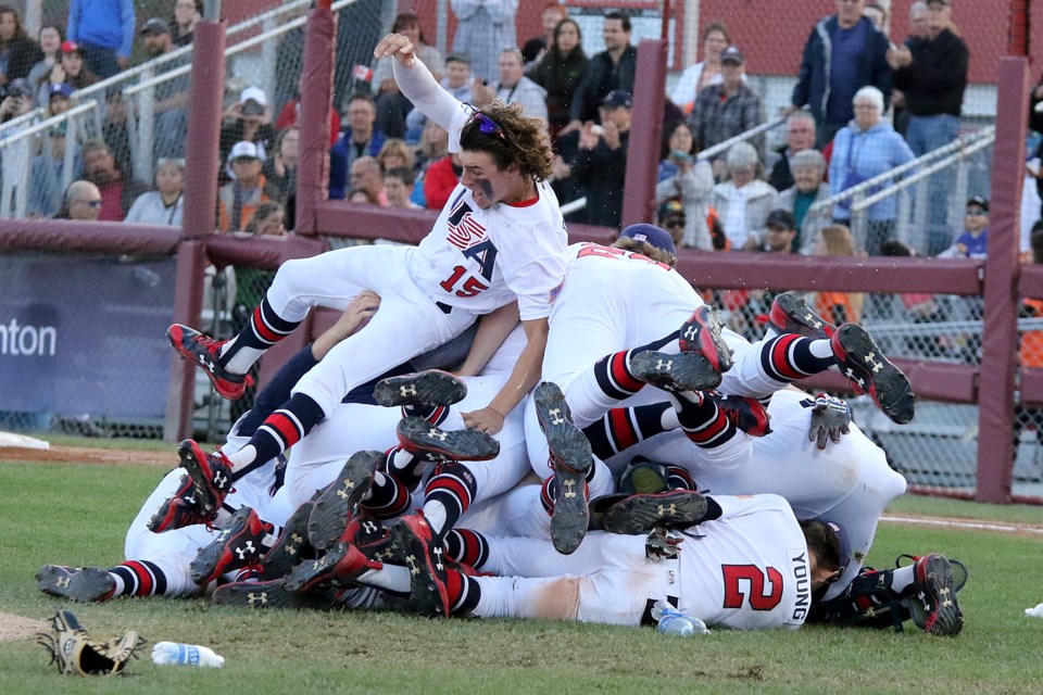 Reynaldo Delgado (15) piles on top of the celebration after United States downed Korea 8-0 in the gold-medal game at the Under 18 World Baseball Cup at Port Arthur Stadium (Leith Dunick, tbnewswatch.com). 