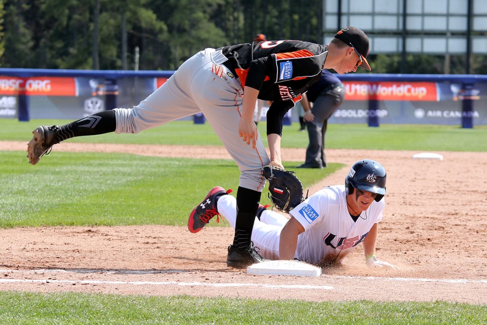 Nolan Gorman of the United States dives back into first base under the tag of Netherlands 1B Tijmen Takke on Friday, Sept. 1, 2017 (Leith Dunick, tbnewswatch.com). 