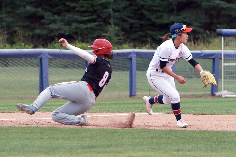 Canada's Sena Catterall slides safely past Hong Kong third baseman Hiu-Tung Wong on Wednesday, Aug. 9, 2023 at the Women's Baseball World Cup Pool A qualifier at Baseball Central in Thunder Bay. (Leith Dunick, tbnewswatch.com)