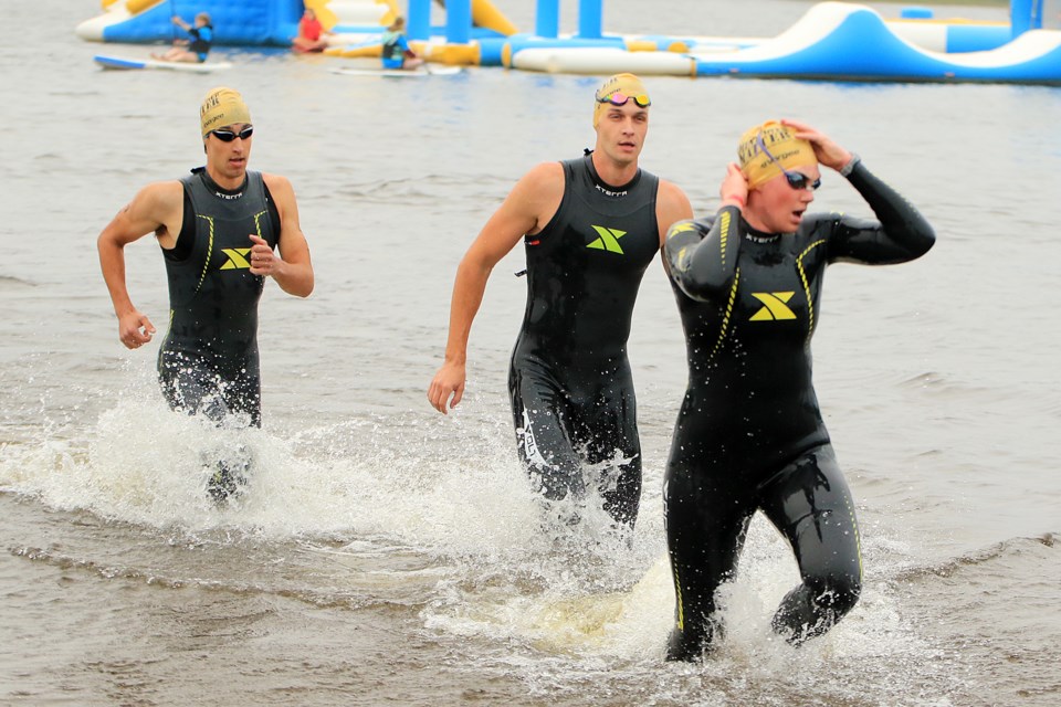 Winner Nicholas Randall (left) comes out of the water on Sunday, Aug. 25, 2024 during the Xterra Triathlon at Boulevard Lake. (Leith Dunick, tbnewswatch.com)