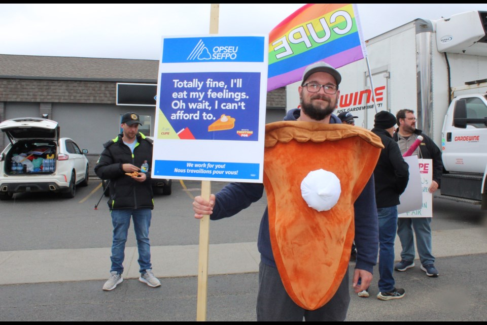 A man dressed as pie demands increased wages for public sector workers.