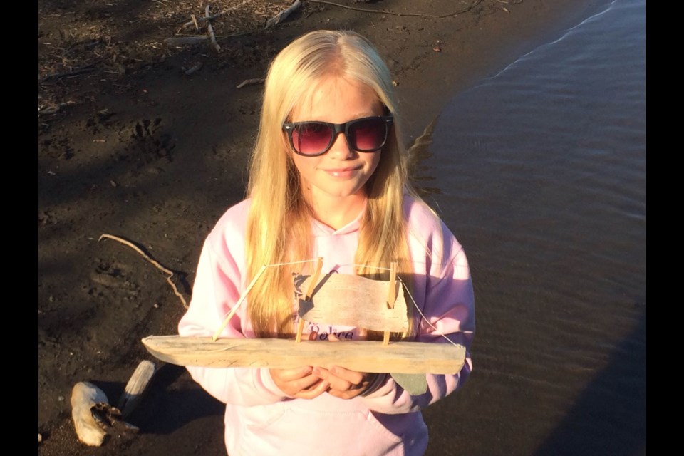 Eleven-year-old Chelsea Ellard is trying to find out who created this uniquely carved schooner found off an island on Lake Superior over the Labour Day longweekend. (photo supplied)