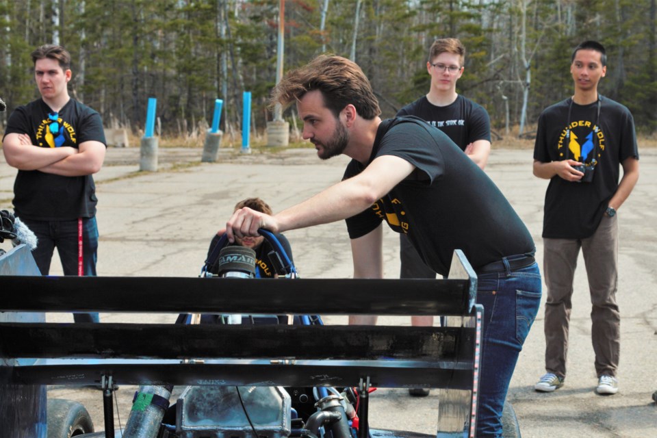 Assistant team captain Matthew Manten inspects the car during a demonstration event at Lakehead earlier this month. (Ian Kaufman, TBnewswatch)