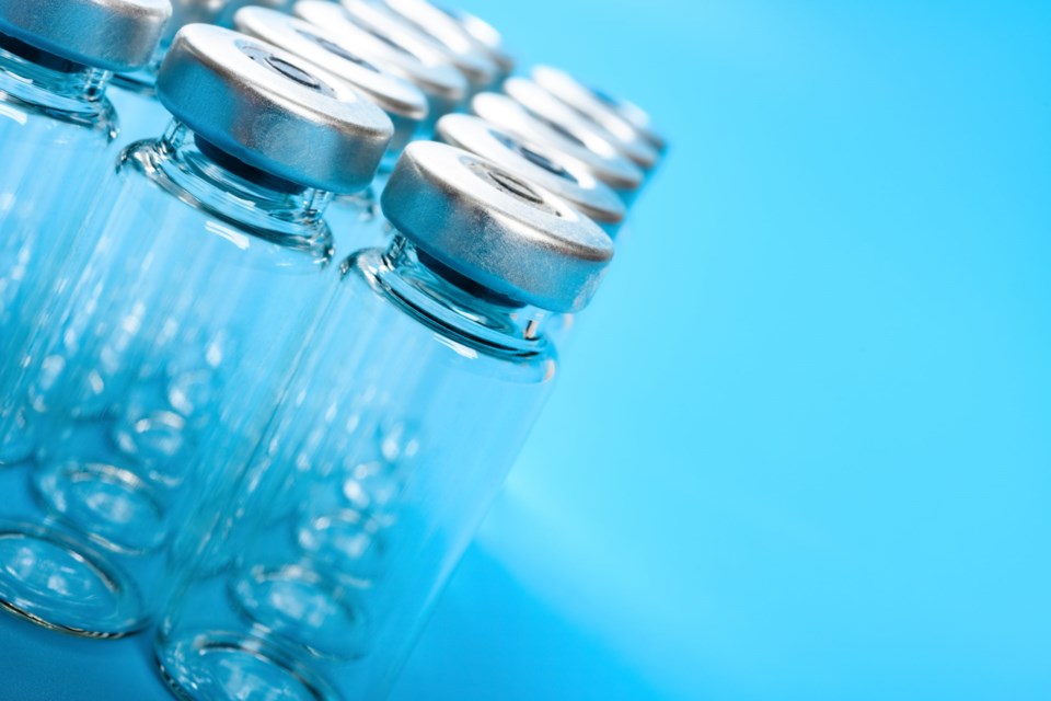 Empty,Vaccine,Bottles,On,Blue,Background,With,Copy,Space