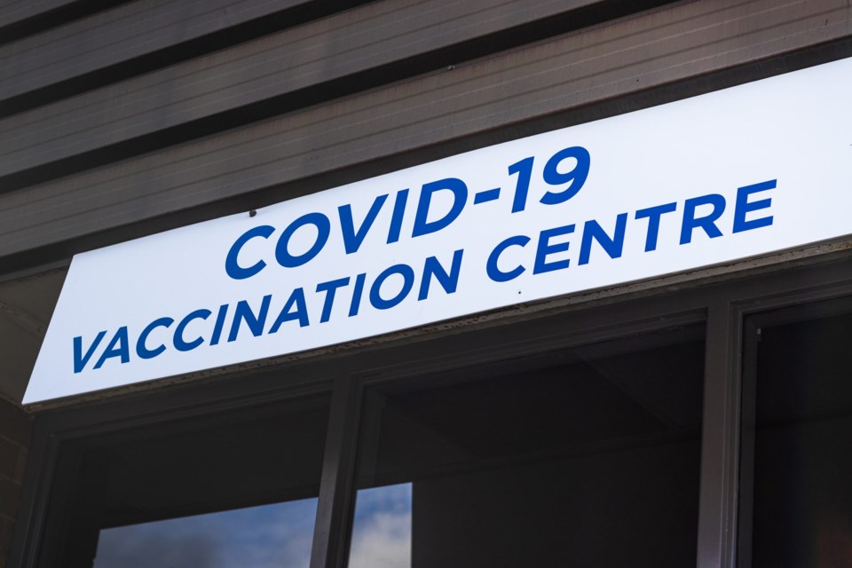 View,Of,Entrance,Building,With,Sign,Covid-19,Vaccination,Centre,In