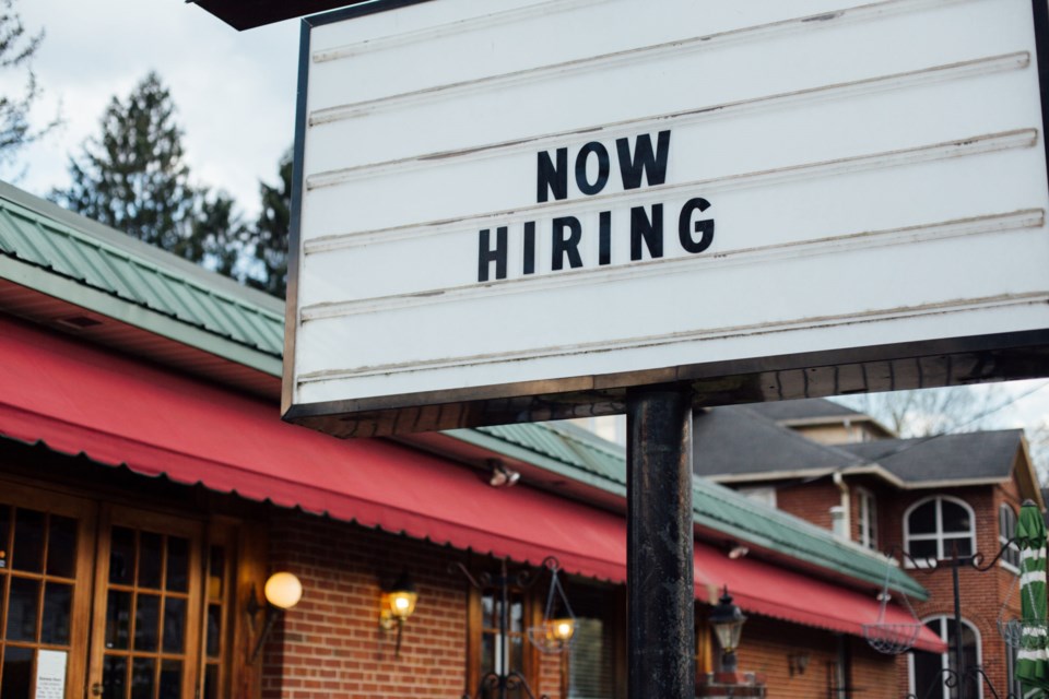 Typical,American,Now,Hiring,Sign,In,Black,Letters,Over,The