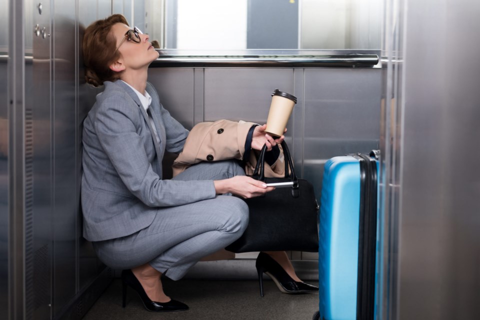 Side,View,Of,Tired,Businesswoman,In,Suit,With,Smartphone,And