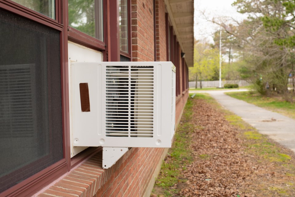 Window,Air,Conditioner,Unit,In,Window,In,Brick,Building,With