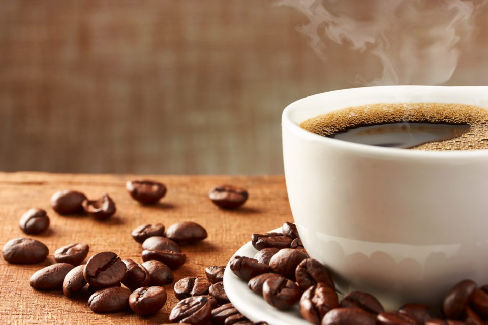 Coffee,Cup,And,Coffee,Beans,On,Table