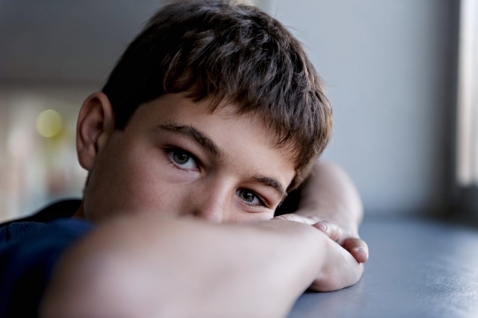 Pensive,Child,Looking,Through,A,Window