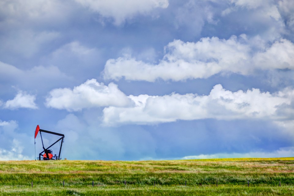 Oil,Derricks,In,Canola,Fields,Outside,Of,Drumheller,Alberta